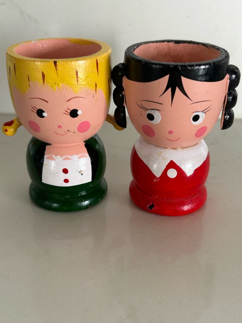 Vintage hand-painted wooden egg cups depicting character faces, 1950s or 1960s.